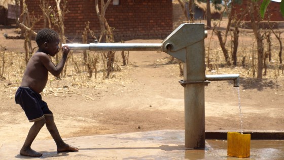 Malawi - boy and borehole - Boy and borehole with water